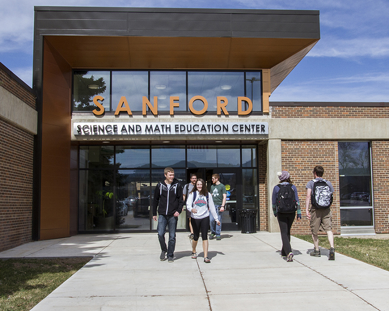 Six students walk outside of the Sanford Science and Math Education Center