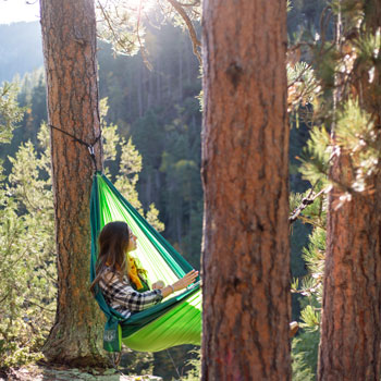 Girl overlooking Spearfish Canyon while hammocking.