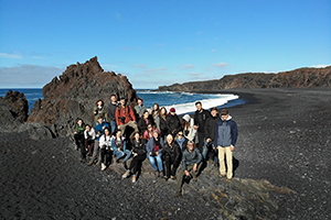 Group of BHSU students standing for a photo on the beach in Iceland.