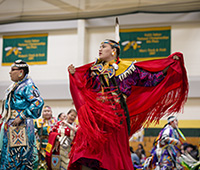 Two Native American people performing a cultural dance at Wacipi