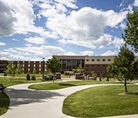 BHSU campus green, Bordeaux and Heidepriem Hall in background with blue cloudy sky