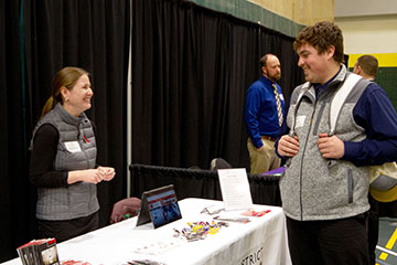 Image of student speaking with employer at the BHSU Teacher Fair