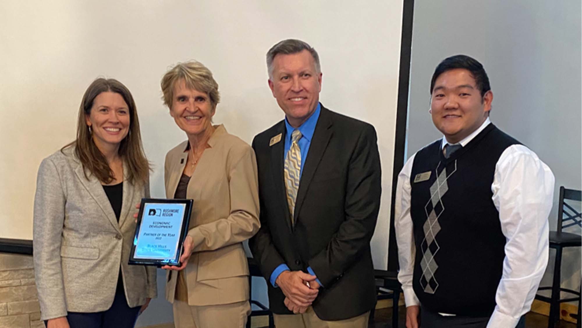 Fran White (left), executive director of BHCED, presents the Rushmore Region Partner of the Year award to BHSU President Laurie S. Nichols, r. Jon Kilpinen, provost and vice president for Academic Affairs, and Jin Kim, director of Career Development at the annual Small Business RoundUP event hosted by Black Hills Community Economic Development. 