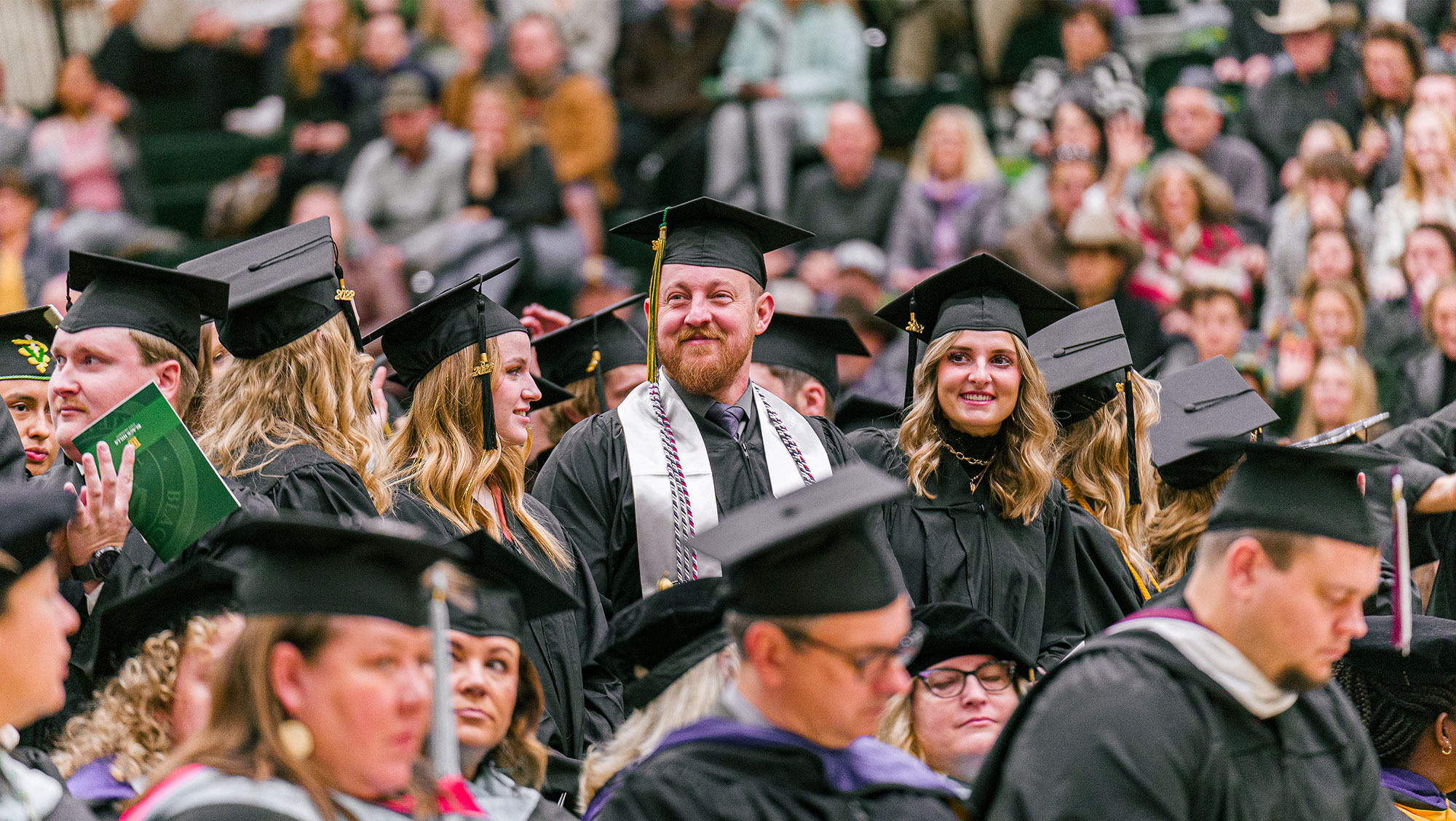 BHSU graduates stand in excited at the Fall 2022 Commencement Ceremony at BHSU.