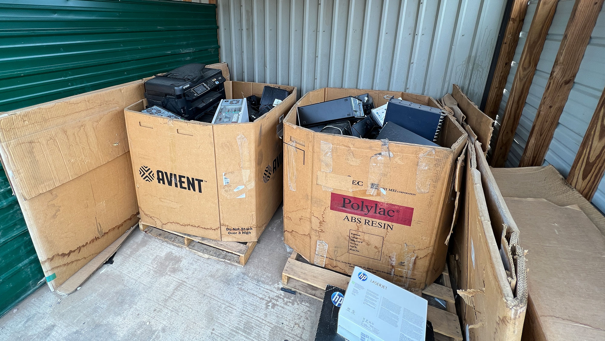 Two boxes of electronic waste sit on pallets ready to be recycled