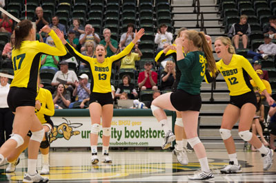Five BHSU volleyball team members celebrate on the court.