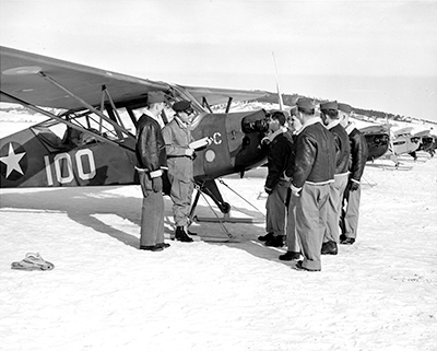 Members of 93rd with airplane.