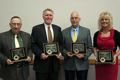 2010 Alumni Award Recipients holding their awards.