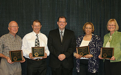 2009 Alumni Award Recipients holding their awards.