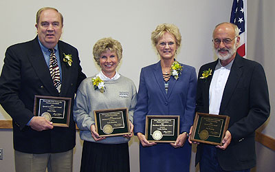 2003 Alumni Award Recipients holding their awards.