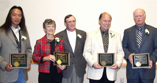 2006 Alumni Award Recipients holding their awards.