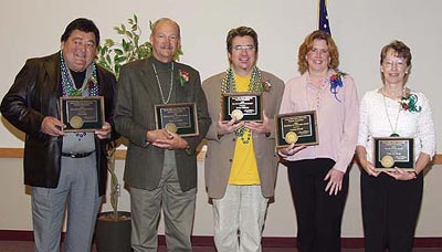 2004 Alumni Award Recipients holding their awards.