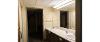 Bordeaux Hall bathroom sinks an entrance into the attached room. 