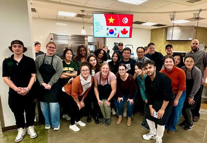 International Students and Kaitlin Palmer, Director of International Relations pose with dining staff.