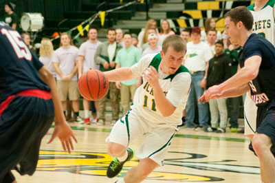 A BHSU basketball player drives the ball toward the hoop.