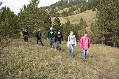 Seven students hike in the Northern Hills.
