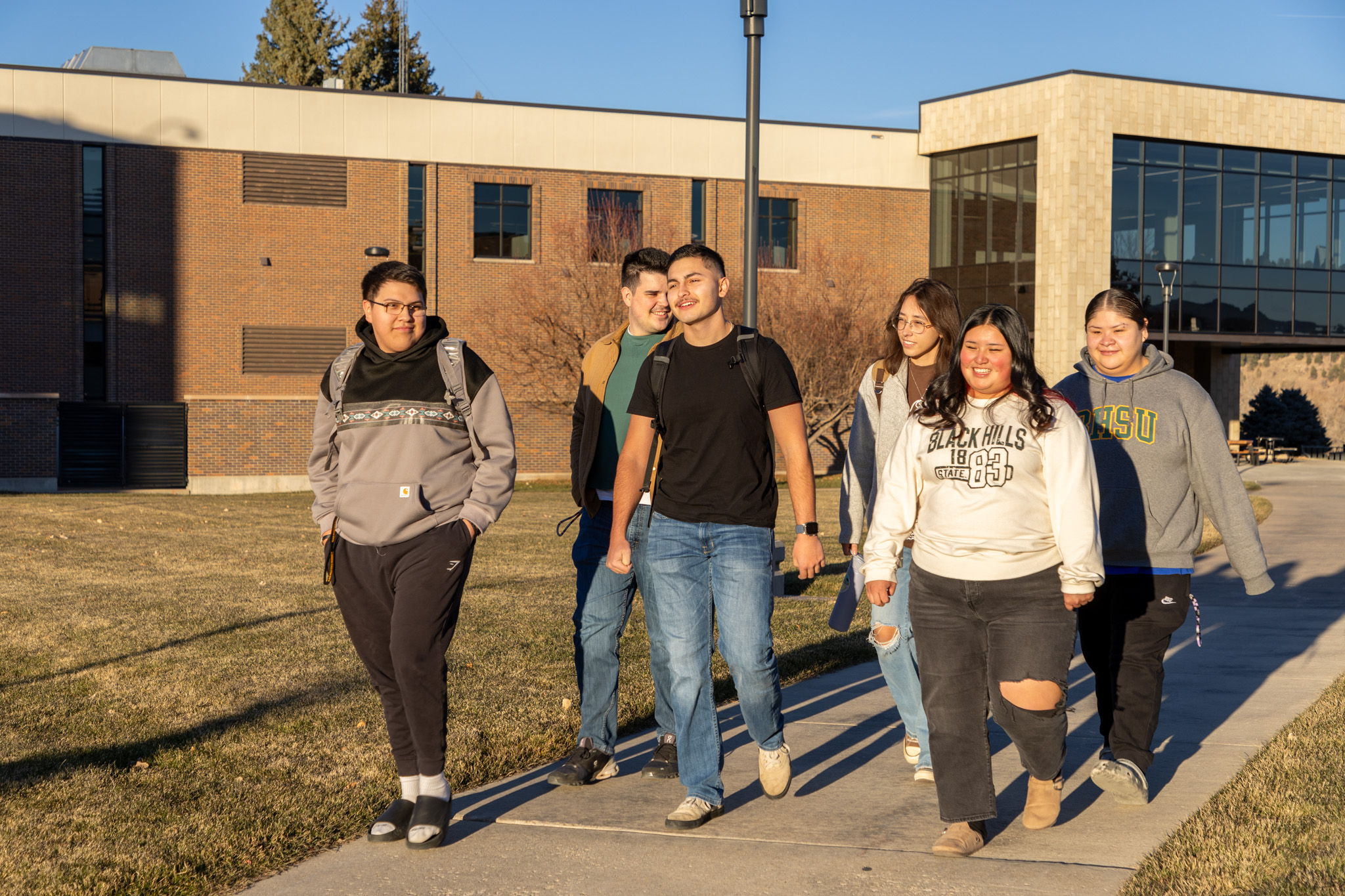 Six students who are active in the Center of American Indian Studies walk together on campus.