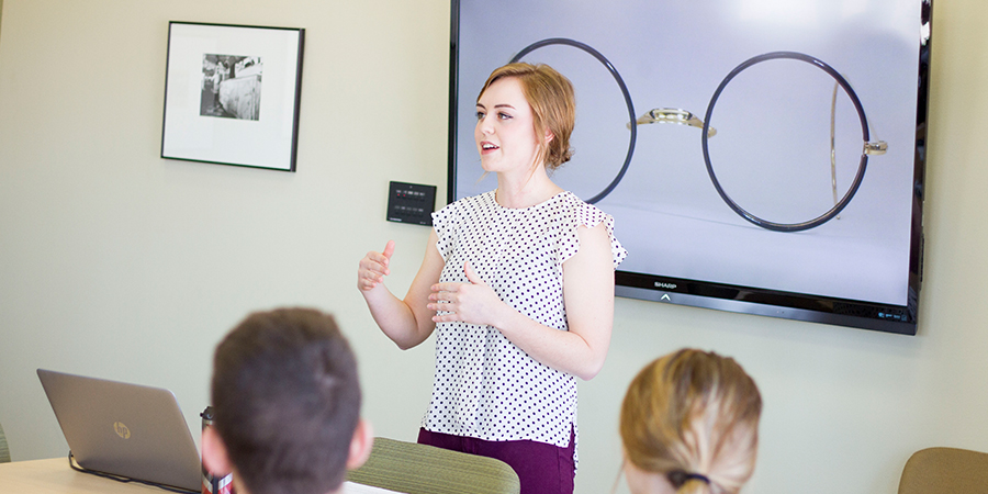 Woman lectures a class.