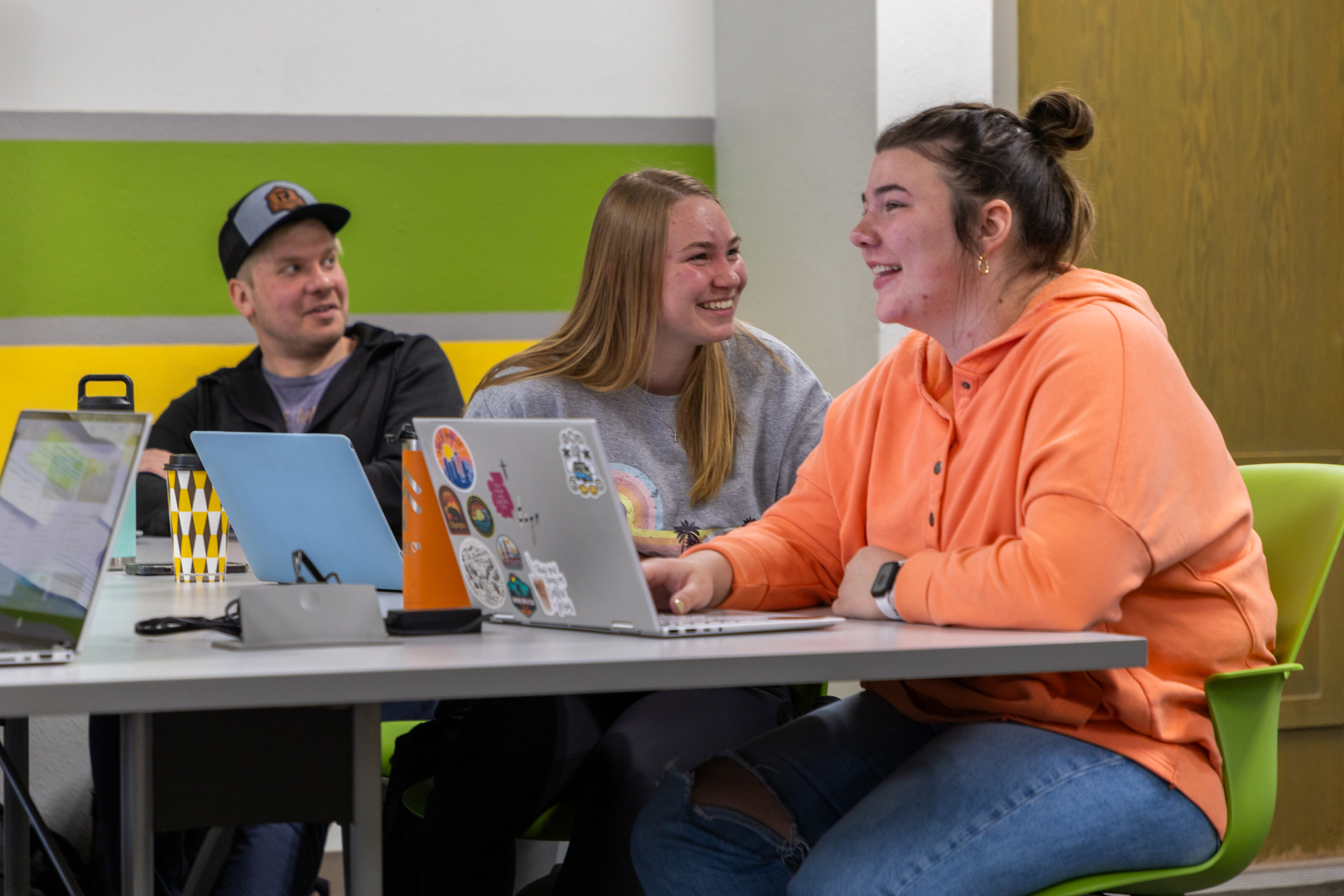 Three BHSU education students sit together in class.