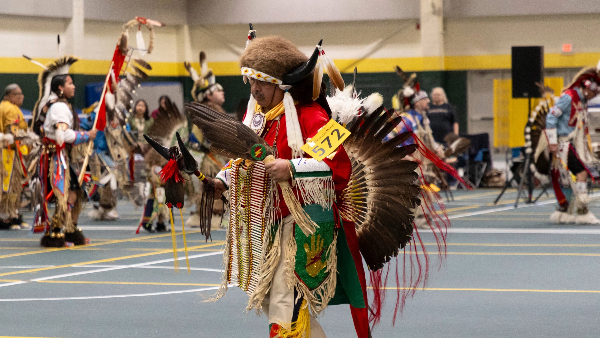 An american indian man dresses in traditional clothing and celebrates his culture at the wacipi