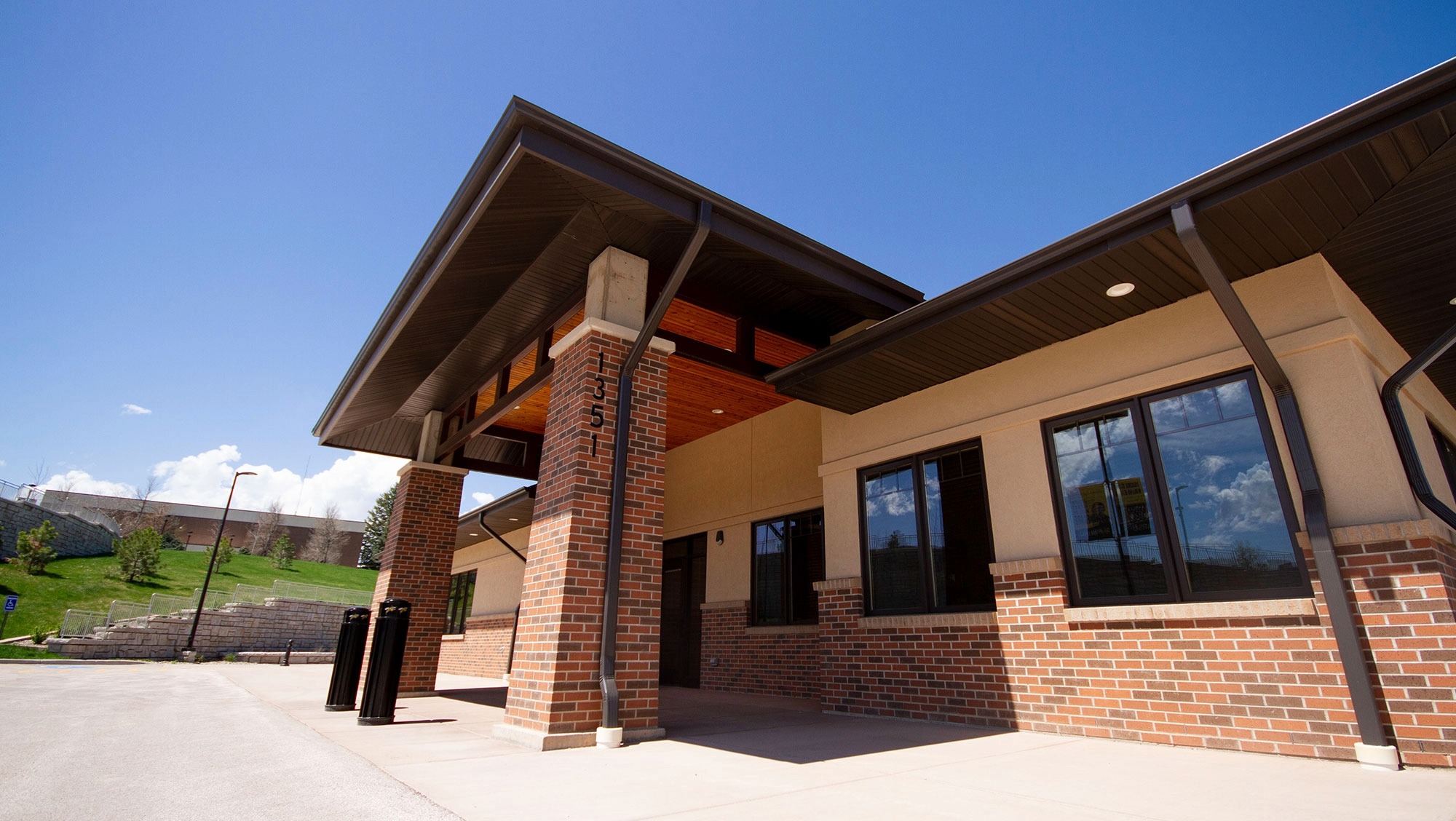 The entrance of a building stands out in front of a campus