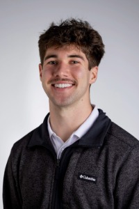 Graduate Connor Hutcheson smiles in his portrait