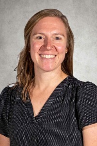 Graduate Erin Oglesby smiles in her portrait