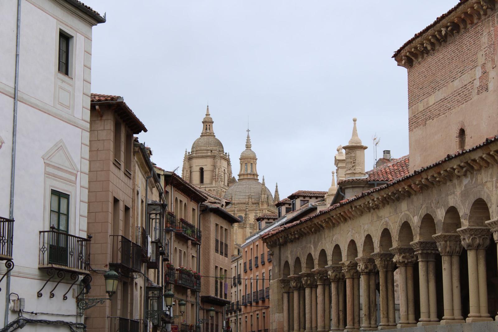 The beautiful streets of a town that opens up to see a large church